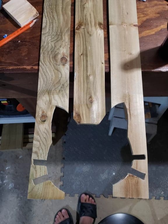 Cutting one section of the cat-face outline from a marked fence picket