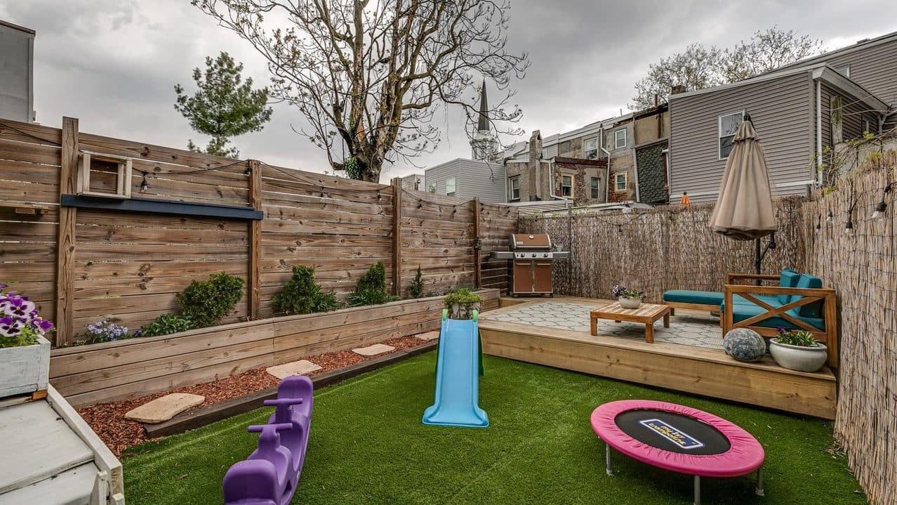 Artificial turf installation around the wooden platform deck