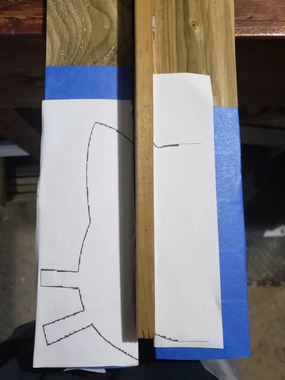 Fence pickets stacked together while the pointed top profile is marked and repeated