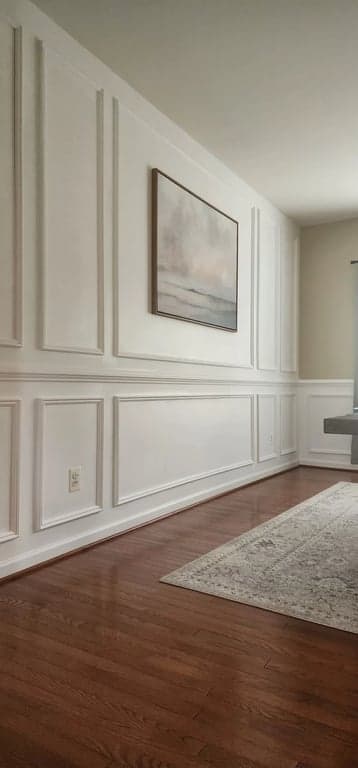 Floor-to-ceiling view of the finished white molding panels along the dining-room wall