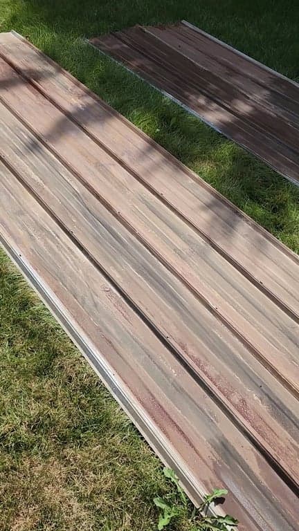 Corrugated metal with even rust patina on grass