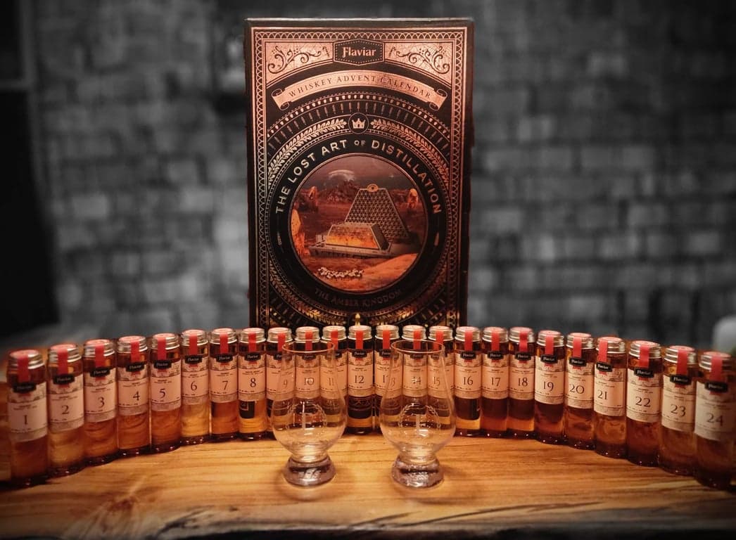 Flaviar Advent Calendar 2023 - Displaying all 24 vials on a spalted maple bar