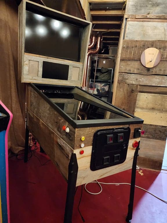 A virtual pinball machine with a pint of beer