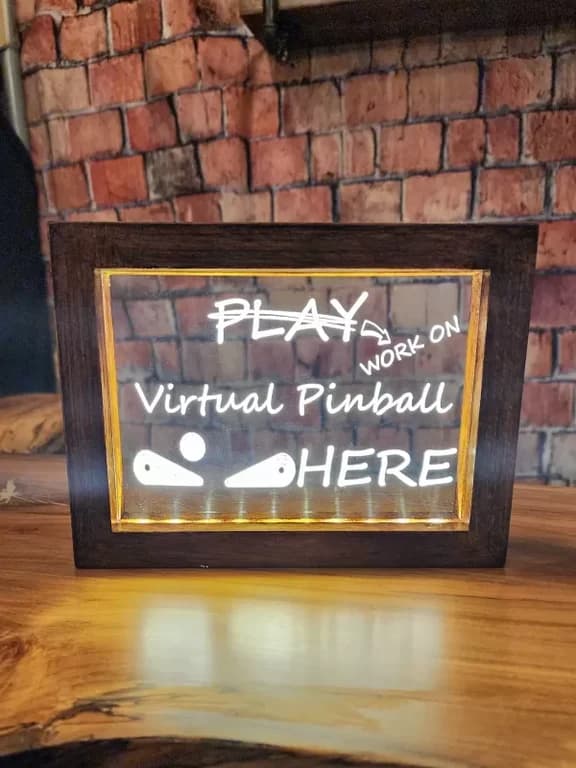Pinbuilders Pride acrylic sign glowing in its handmade wooden frame