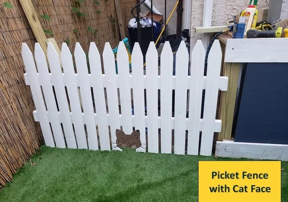 Finished white cat-face picket gate standing in the backyard with the full opening visible