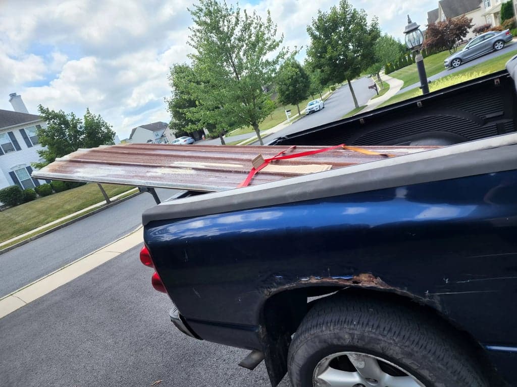 Pickup truck with rusted corrugated metal sheets
