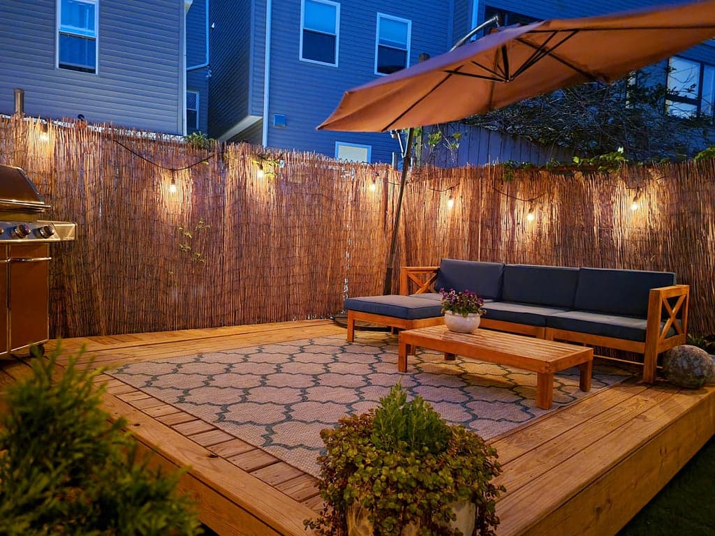 Evening view of the backyard with string lights illuminated