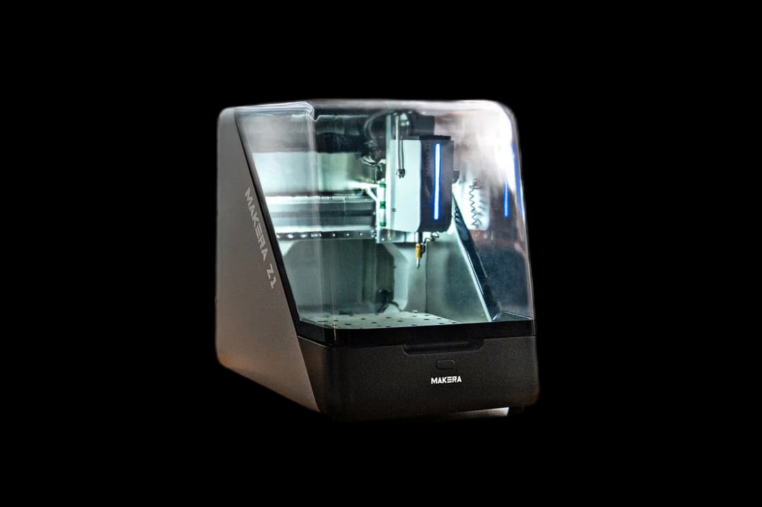 Official Makera Z1 desktop CNC product photo on a workshop desk