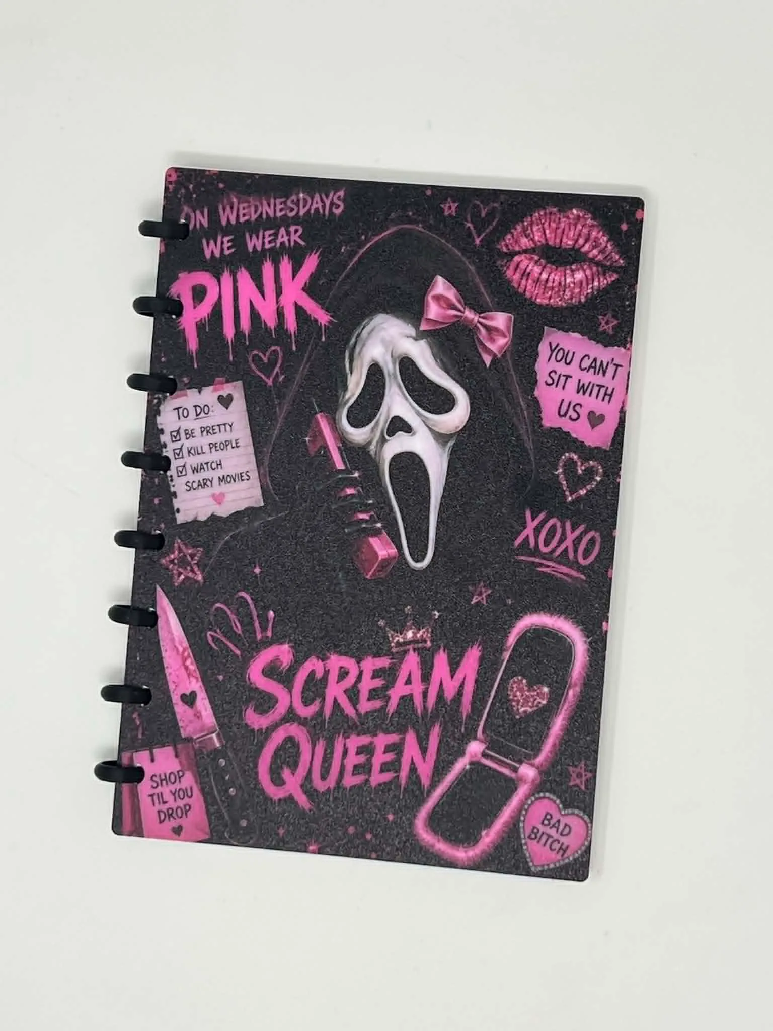 A5 disc-bound notebook with a dark horror-themed UV printed cover in pink and black, bound by black 3D printed rings.